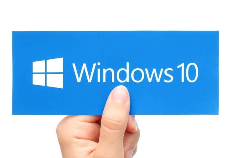 Hand holds Windows 10 logotype printed on paper