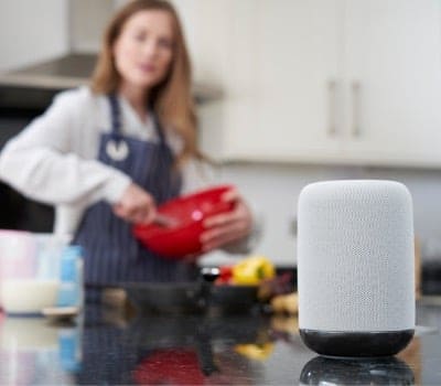 Woman using digital assistant while cooking