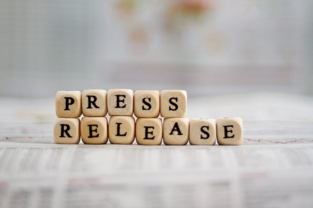 Wooden cubes with letters that together spell "Press release"