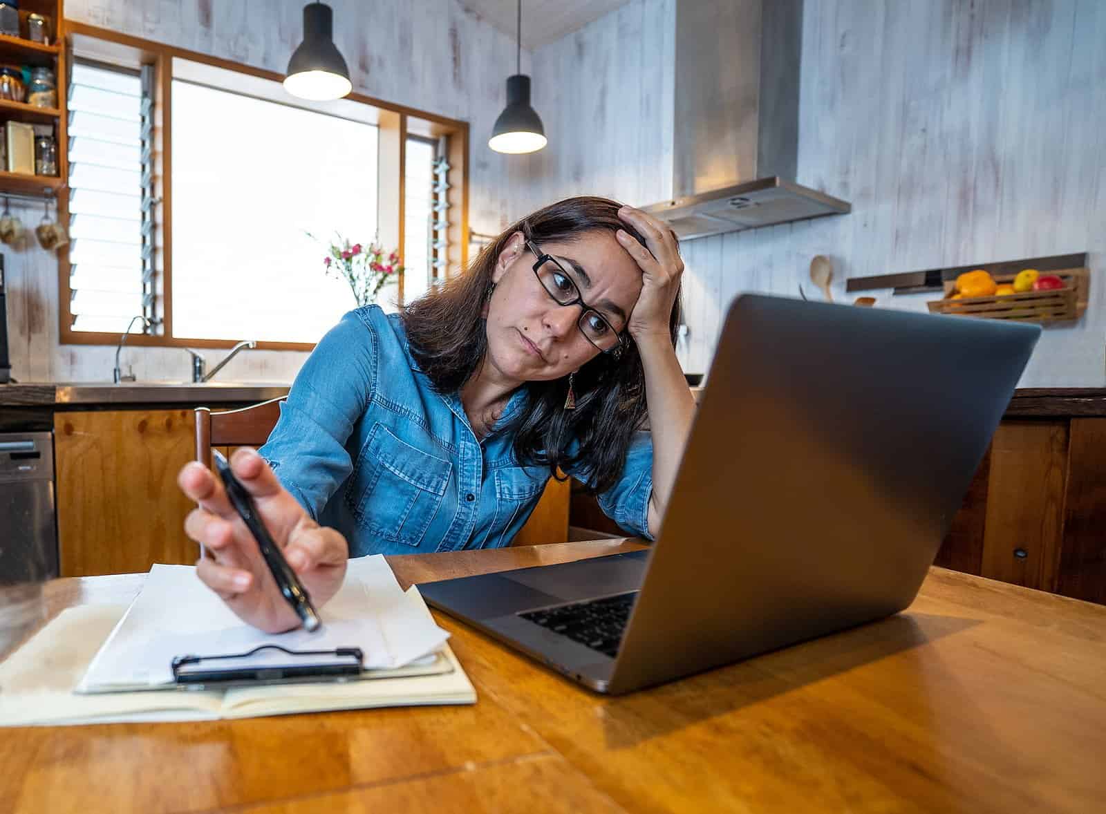 Stressed Business Woman Working From Home On Laptop Looking Worr