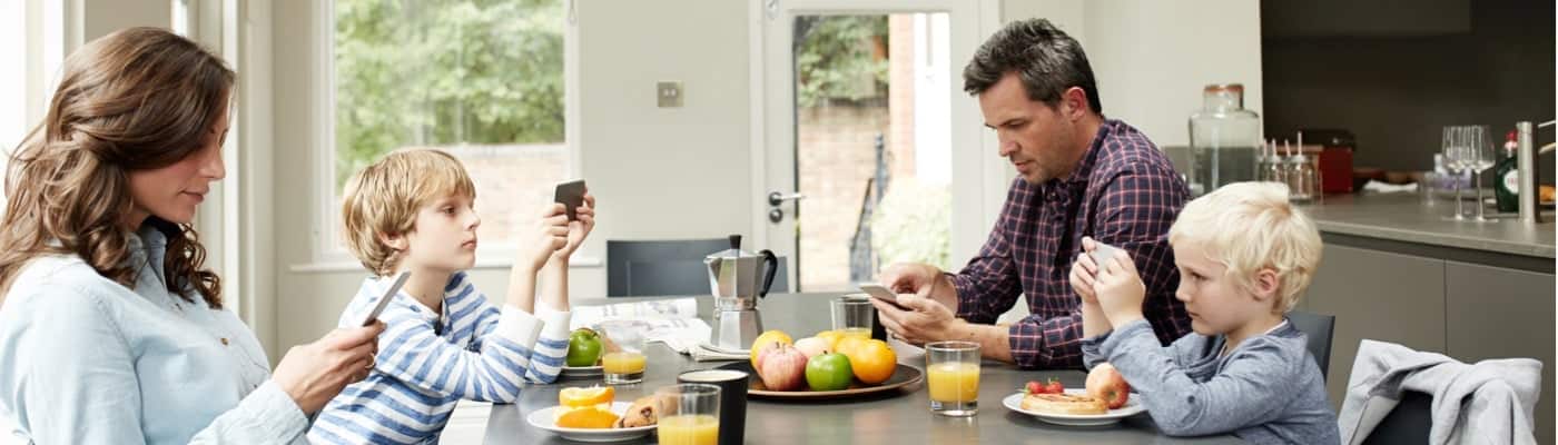 family distracted by mobile devices