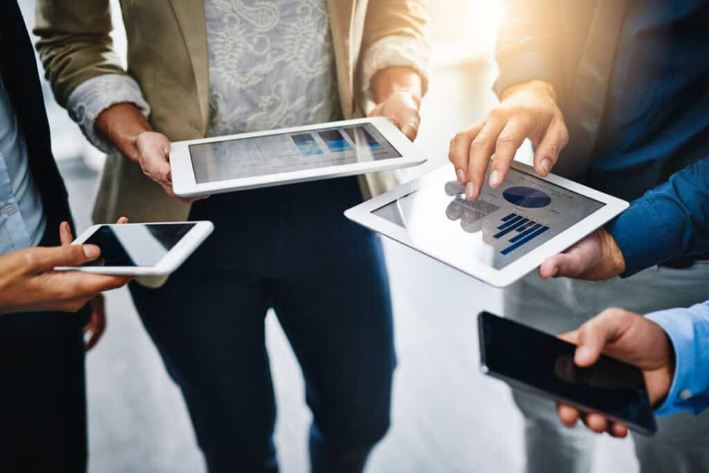 Group of people with tablets working using mobile technologies.