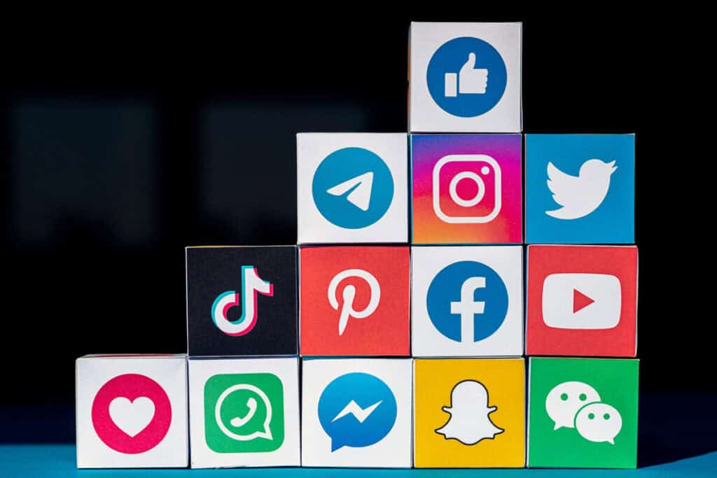 Social media icons on cubes, highlighting big data ethical dilemmas.