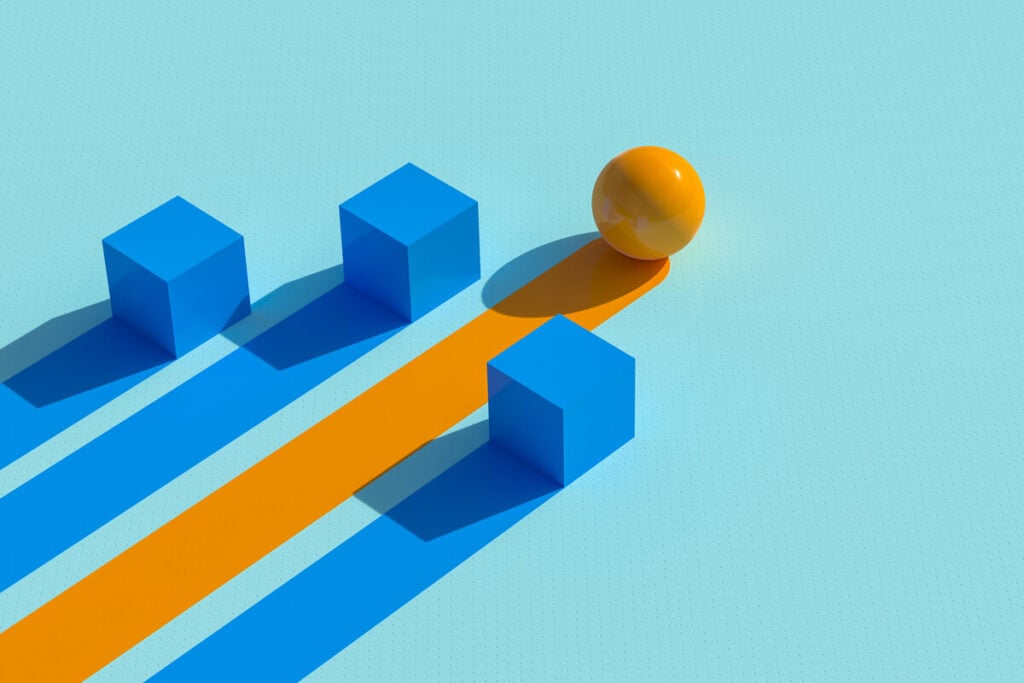 A yellow sphere follows an orange path, bypassing three blue cubes on a light blue background. The scene illustrates overcoming obstacles, symbolizing the definition of business continuity.